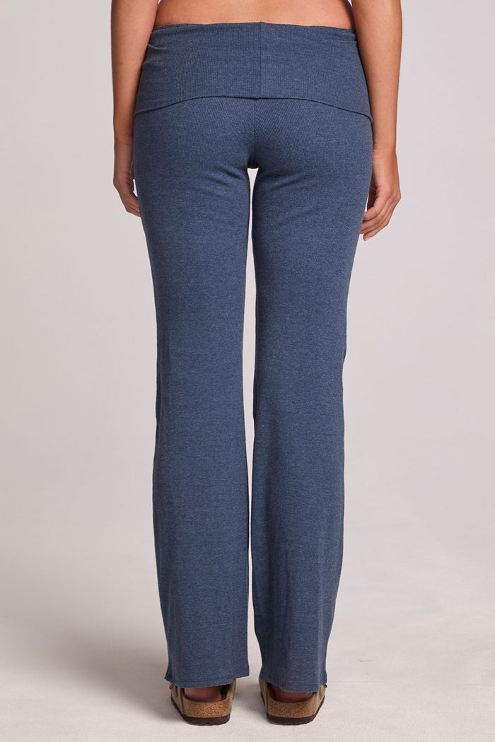 Back view of a woman wearing the Chaser Noorh Dark Denim Pants with arms down at side