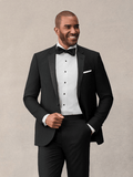 Close-up of man in black notch lapel tuxedo jacket with bow tie and white pocket square