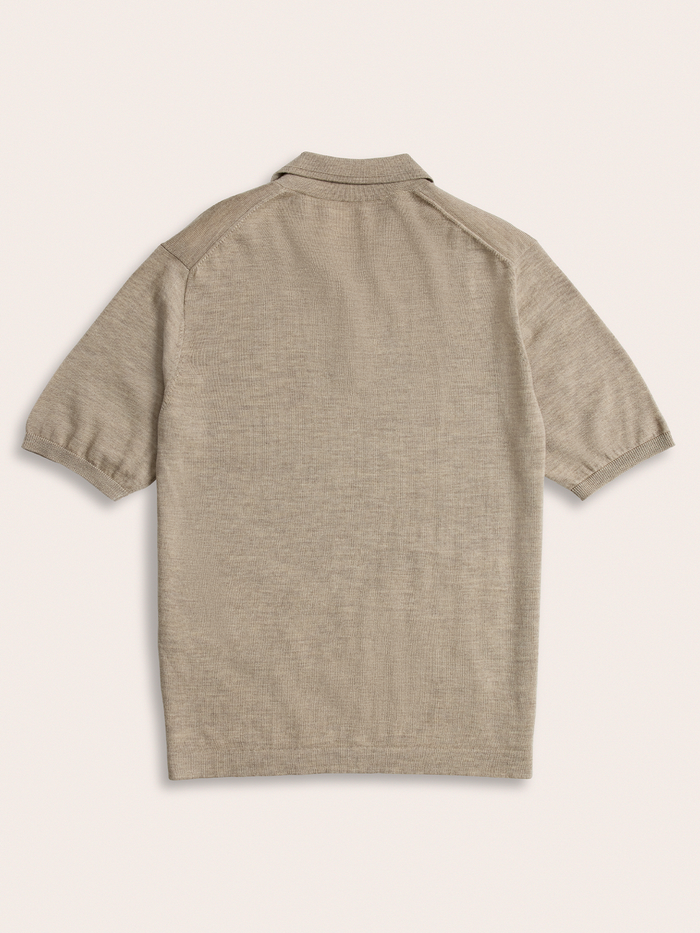 Oatmeal knit polo shirt laid flat, back view, on cream background