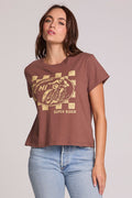 Front view of a woman wearing the Chaser Off Road Race Team Graphic Tee on a neutral background