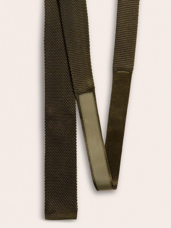 Back of olive green knit silk tie showing woven texture and keeper loop