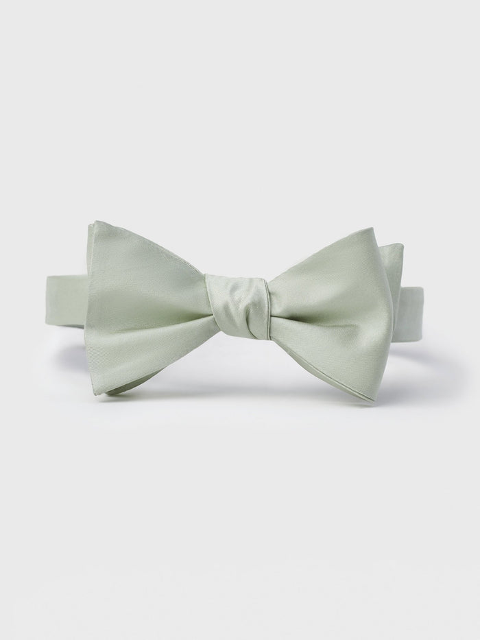 Pale seafoam green silk bow tie on white background