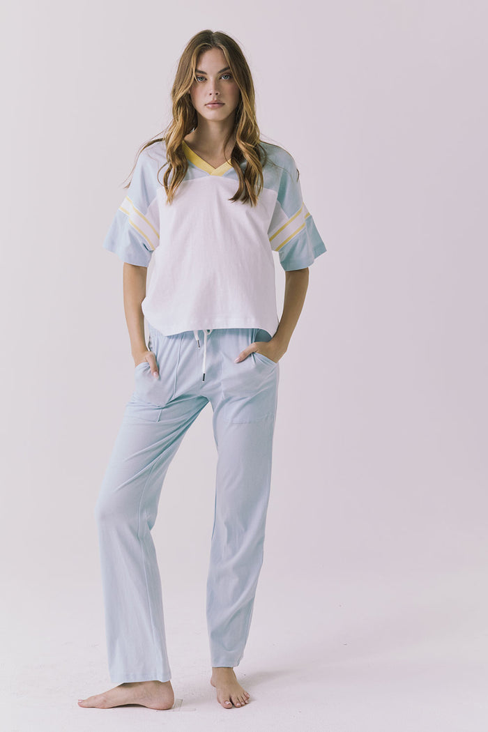 Chaser Palmer Tee in White with Mineral Butter trim styled solo with denim showcasing the relaxed sporty silhouette