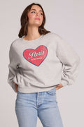 Back view of a woman wearing the Chaser Paris is For Tee on a neutral background with blue jeans and arms on hips