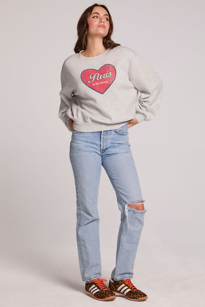 A full body front view of a woman wearing the Chaser Paris is For Tee on a neutral background