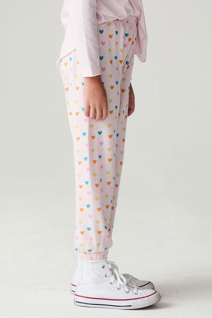 Side view of a girl wearing the Chaser Party Hearts Girls Jogger on a neutral background with hands at sides
