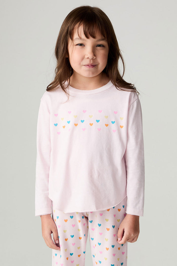 Front view of a girl wearing the Chaser Party Hearts Girls Tee on a neutral background with matching shirt