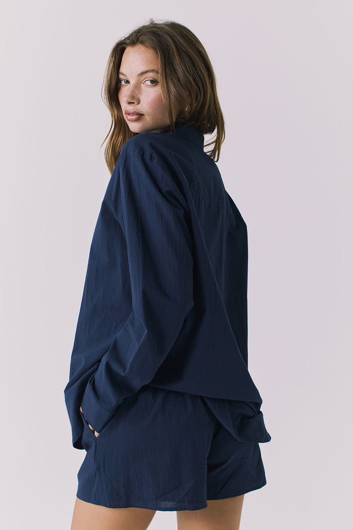 Chaser Paso Navy Button Up in Navy shown from over shoulder back view with fluid drape