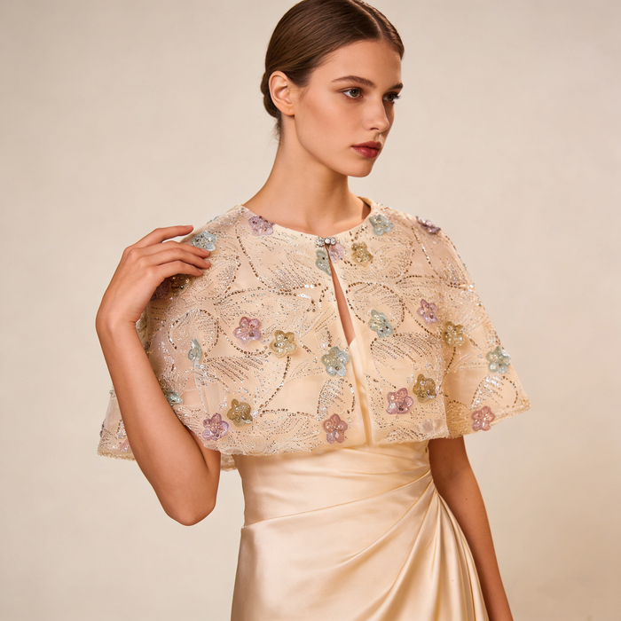 Luxury bridal cape featuring pastel flowers, shimmering sequins and soft tulle.