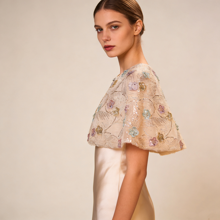 Luxury bridal cape featuring pastel flowers, shimmering sequins and soft tulle.