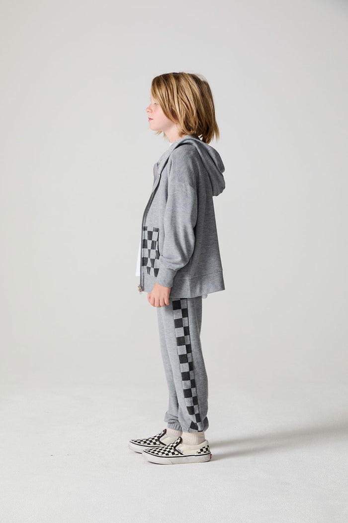 Full body side view of a boy wearing the Chaser Paxton Heather Grey Zip Up Hoodie on a neutral background
