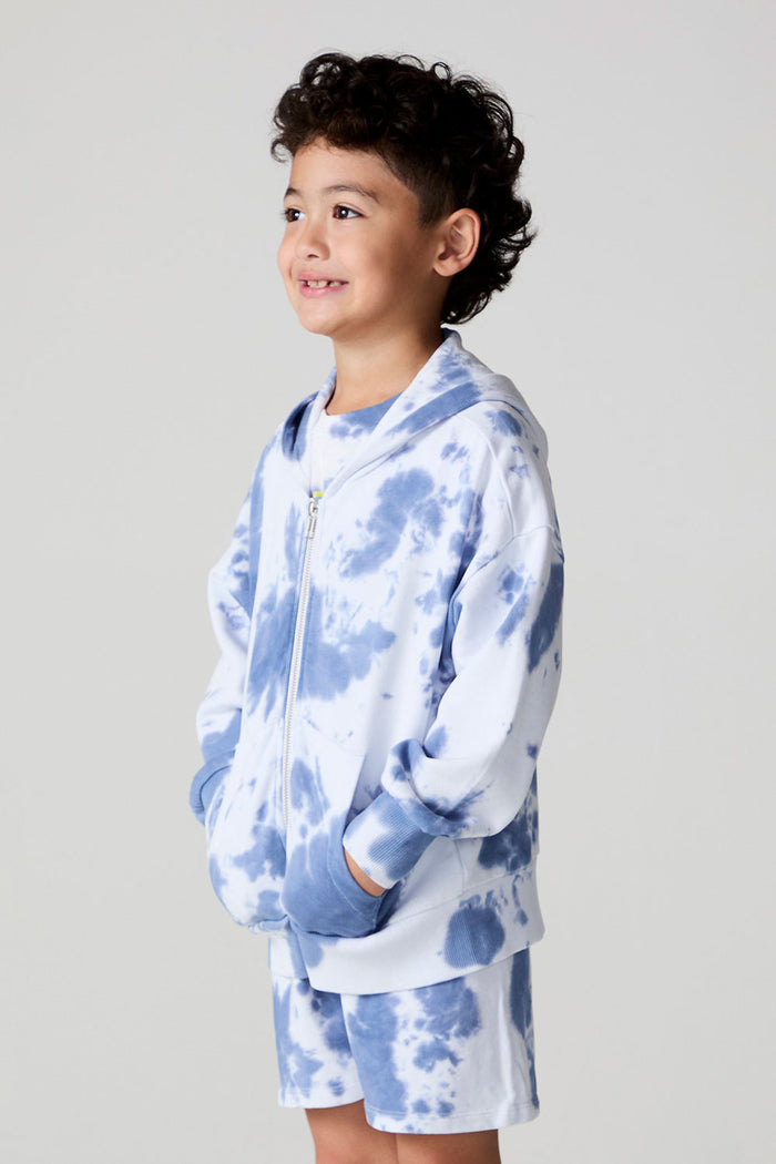 Side angle view of a boy wearing the Chaser Paxton Mistel Tie Dye Zip Up Hoodie on a neutral background
