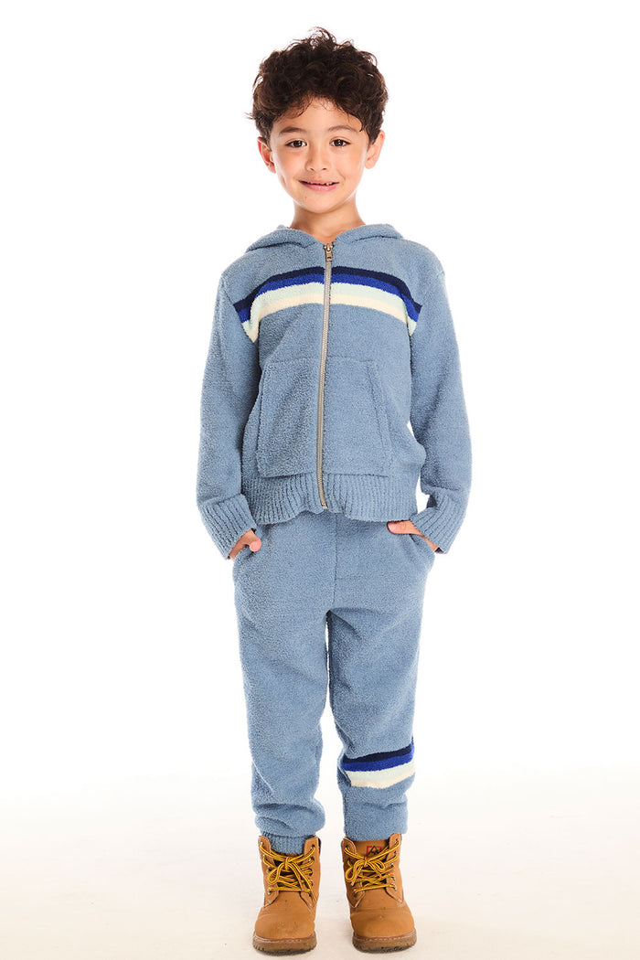 Full body view of boy wearing Chaser’s Paxton Zip Up true blue hoodie and matching pants on a white background