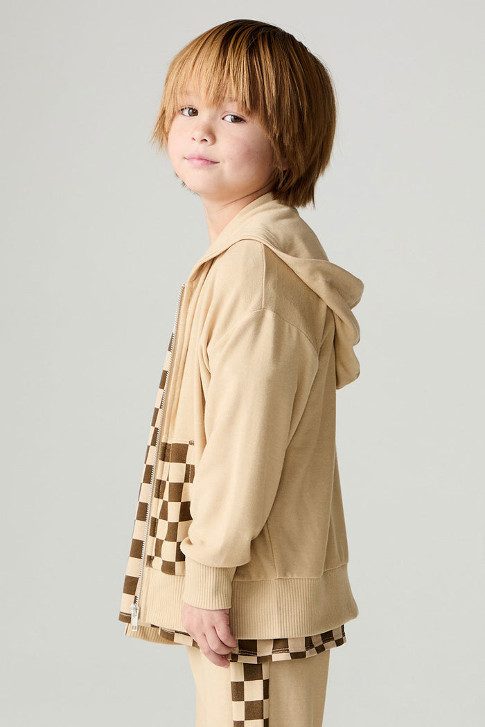 Side view of a boy wearing the Chaser Paxton Zip Up Hoodie Boys Zip Hoodie on a neutral background with hands at sides