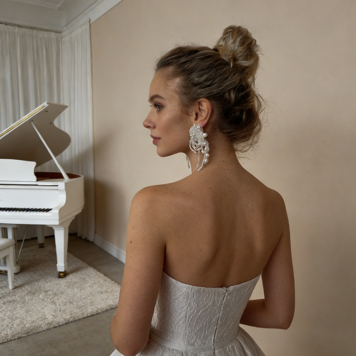 Handcrafted pearl beaded bridal earrings featuring natural freshwater pearls, white crystals and elegant tassel details for luxury weddings.