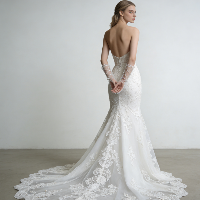 Full-length bridal gown styled with handcrafted pearl beaded tulle gloves creating an elegant wedding look.