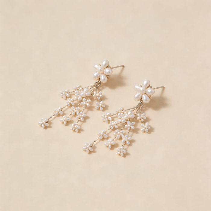 Freshwater pearl flower bridal earrings with platinum plated details and cascading floral cluster design.