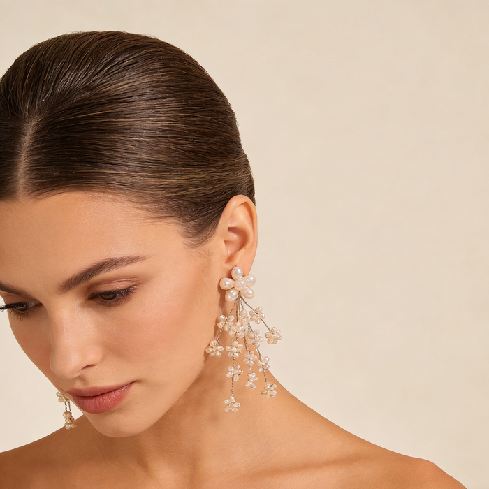 Freshwater pearl flower bridal earrings with platinum plated details and cascading floral cluster design.