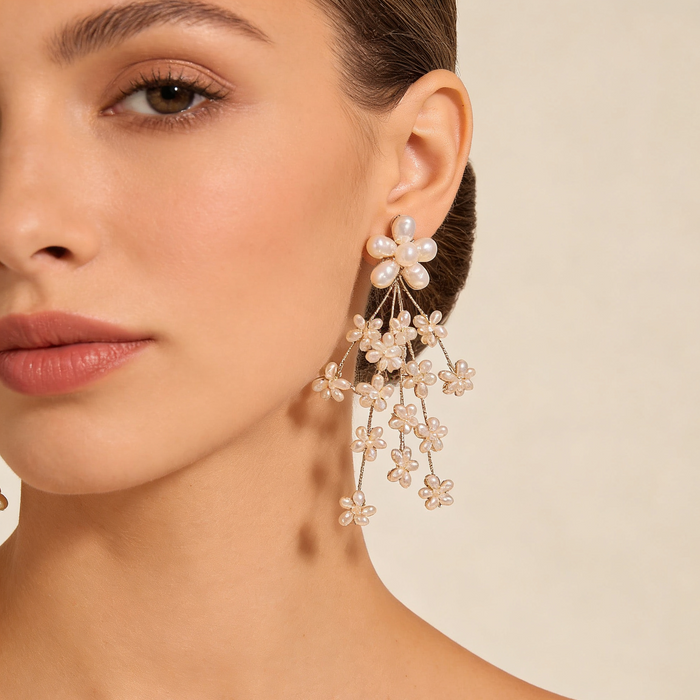 Freshwater pearl flower bridal earrings with platinum plated details and cascading floral cluster design.