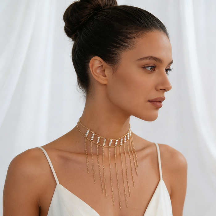Bride wearing a freshwater pearl fringe choker necklace with a modern wedding gown during an elegant bridal portrait.