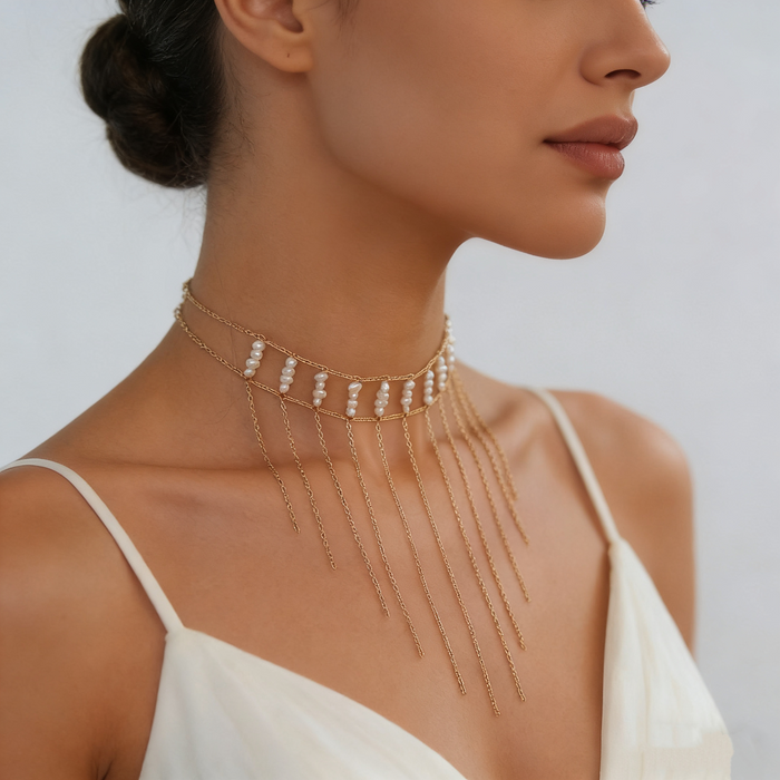 Bride wearing a freshwater pearl fringe choker necklace with a modern wedding gown during an elegant bridal portrait.