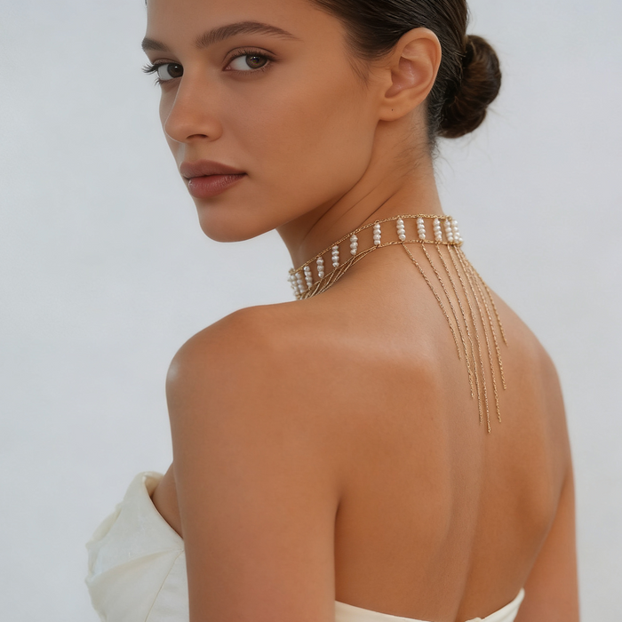 Bride wearing a freshwater pearl fringe choker necklace with a modern wedding gown during an elegant bridal portrait.