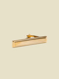 Brushed gold picture-frame tie bar on cream background