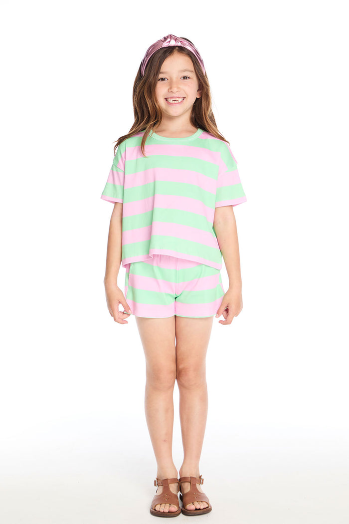 Girl wearing the Chaser Kids Pinky Aloe Stripe Devin Tee paired with the matching Pinky Aloe Stripe Jade Short, styled with sandals and a metallic pink headband on a white background