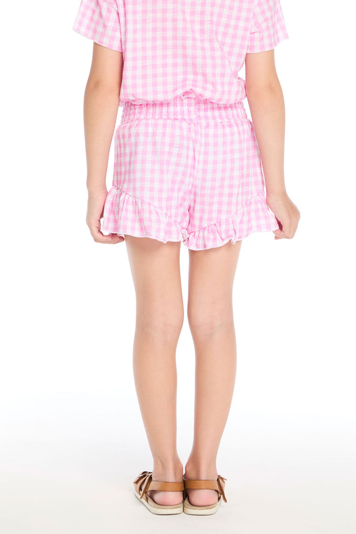 Back view of the Chaser Kids Pinky Gingham Grotto Shorts highlighting the elastic waistband and playful ruffle detail along the hem