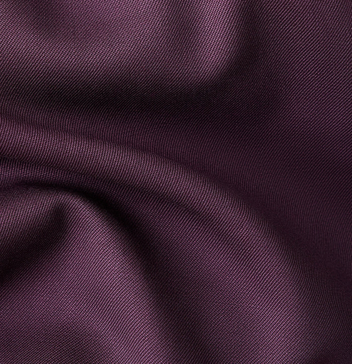 Close-up of plum wool twill fabric texture with soft draped folds
