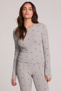 Front view of a woman wearing the Chaser Porta Light Heather Grey Long Sleeve on a neutral background with matching pants