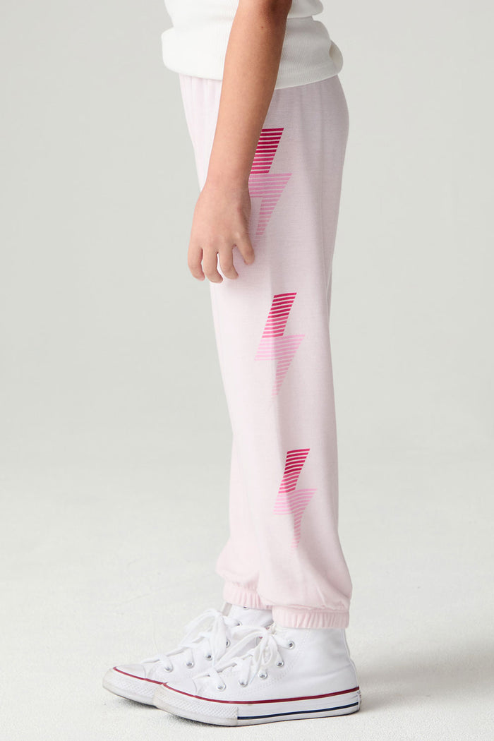 Side view of a girl wearing the Chaser Power Bolt Girls Jogger and sneakers on a neutral background
