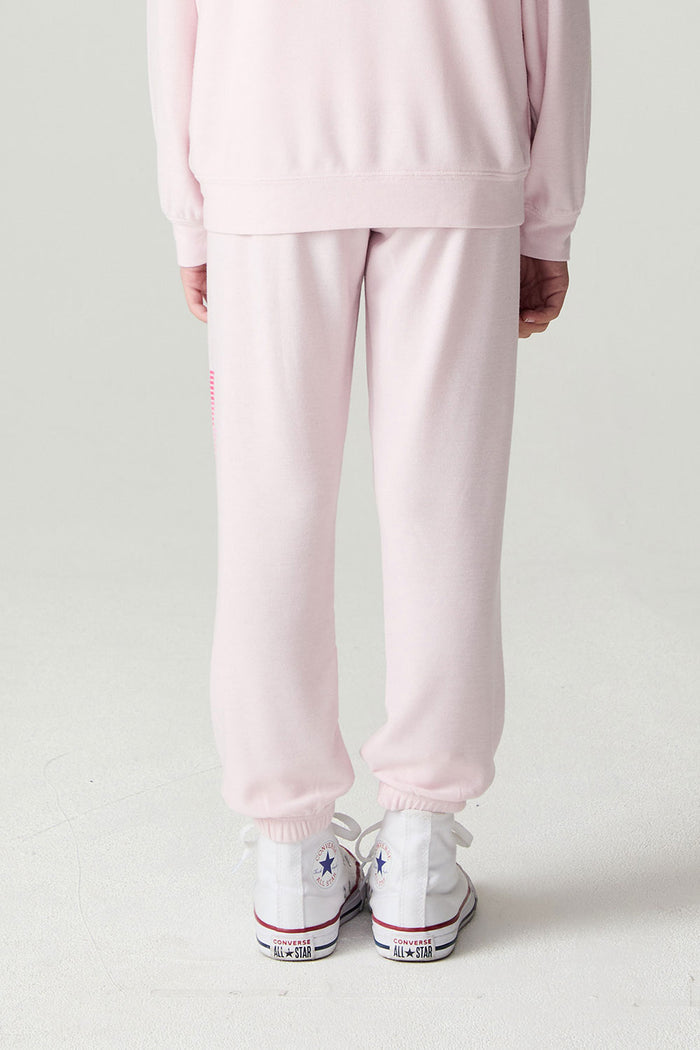 Back view of a girl wearing the Chaser Power Bolt Girls Jogger on a neutral background