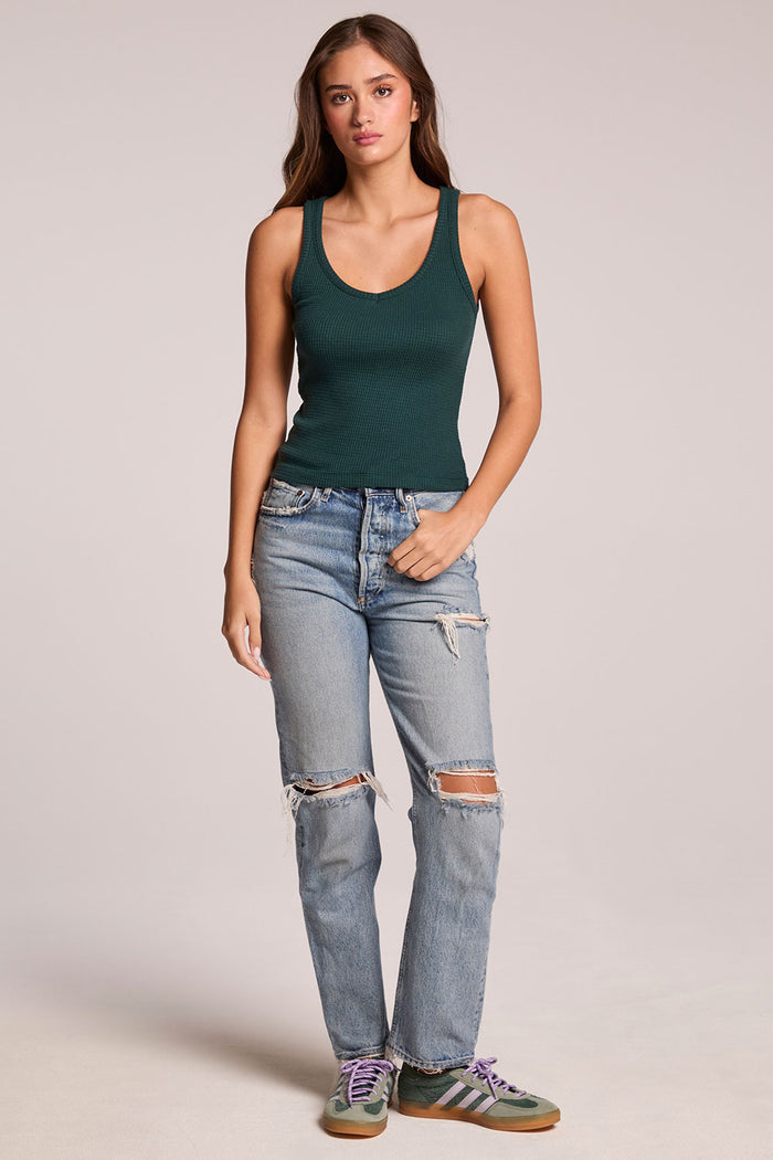 Full body ront view of a woman wearing the Chaser  Prescot Pine Green Tank Top and sneakers on a neutral background