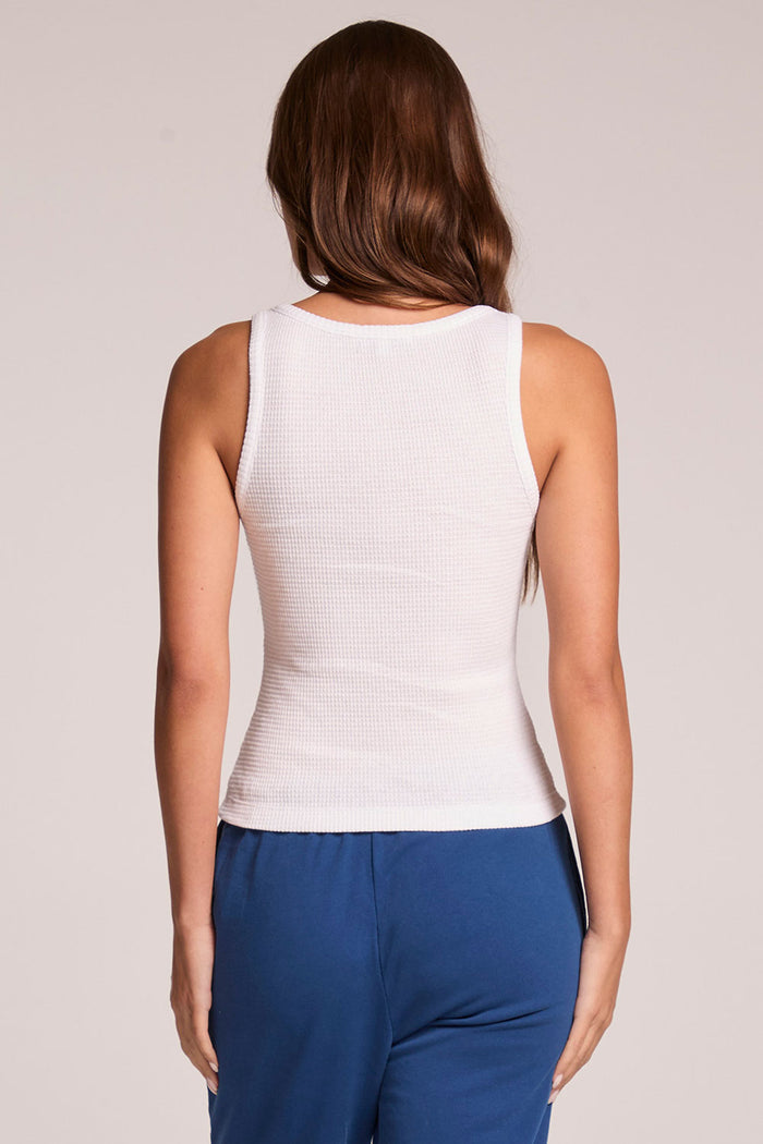 Back view of a woman wearing the Chaser   Prescot White Tank Top on a neutral background