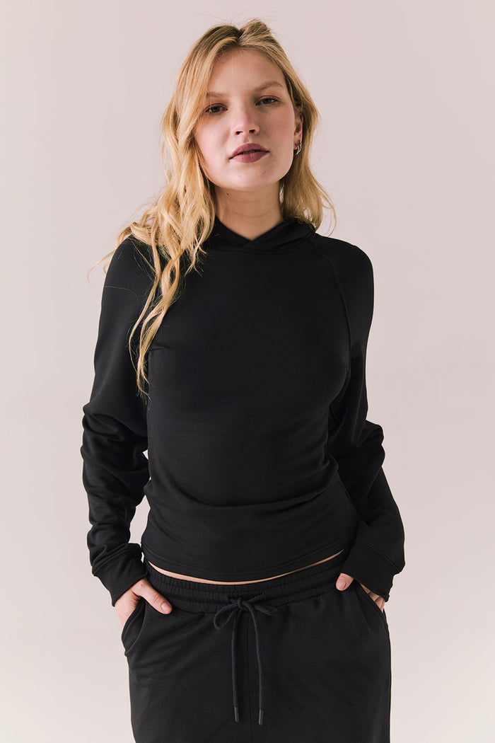 True black pullover hoodie with minimalist design and soft finish.