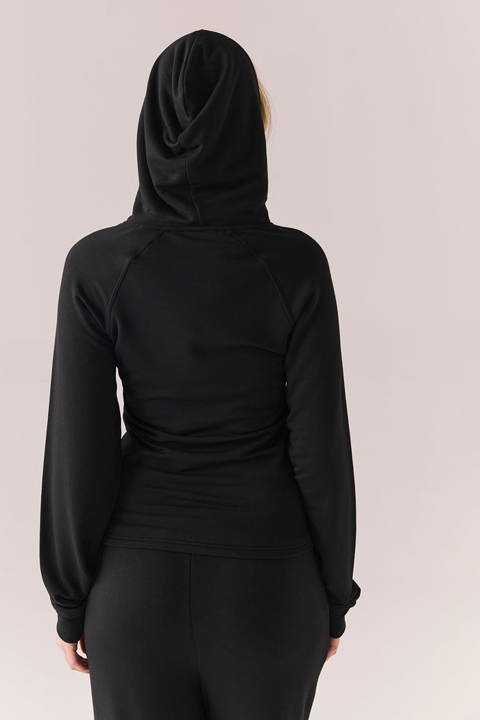 Back of black modal hoodie with no graphic and streamlined silhouette.