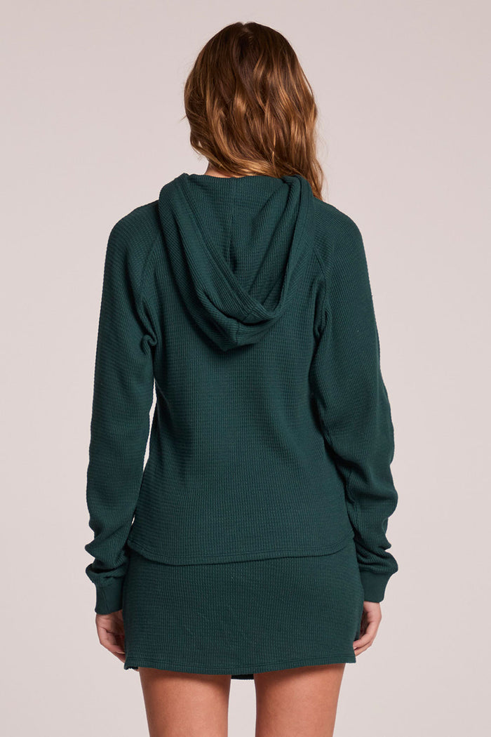 Back view of a woman wearing the Chaser  Providence Pine Green Hoodie on a neutral background