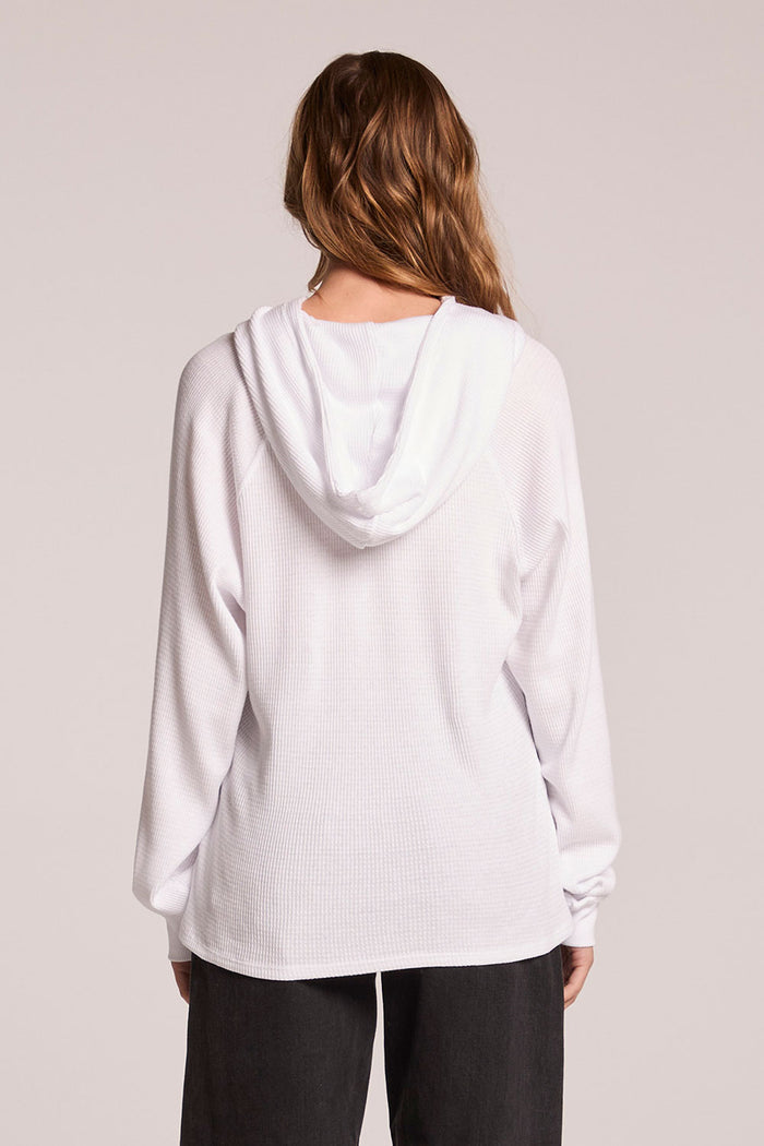 Back view of a woman wearing the Chaser   Providence White Hoodie on a neutral background
