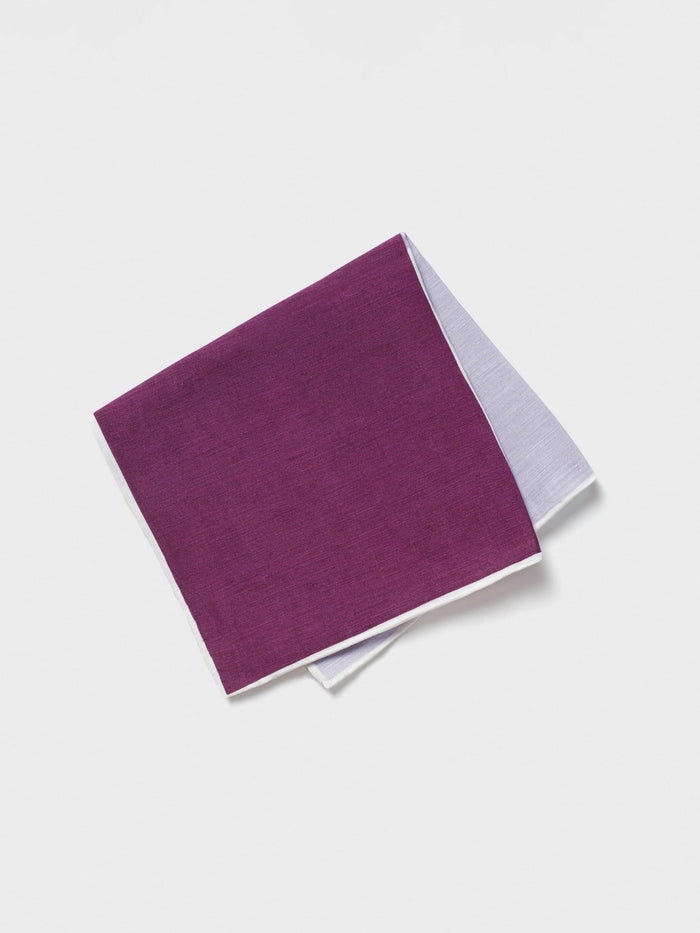 Purple pocket square folded in quarters, dark purple and white sides visible