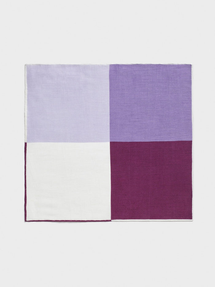 Purple, lavender, and white quad-pattern pocket square laid flat