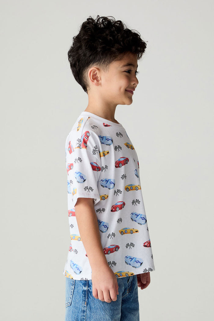 Side view of a boy wearing the Chaser Race Day Boys Tee on a neutral background with bluejeans