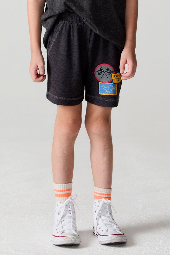 Front view of a boy wearing the Chaser Race Patches Shorts on a neutral background