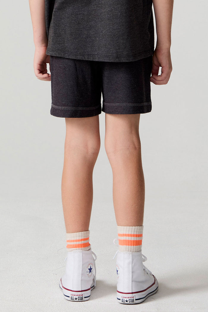Back view of a boy wearing the Chaser Race Patches Shorts on a neutral background