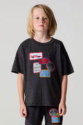 Front view of a boy wearing the Chaser Race Patches Tee on a neutral background