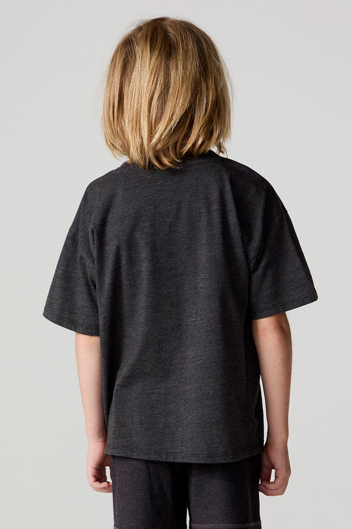 Back view of a boy wearing the Chaser Race Patches Tee on a neutral background