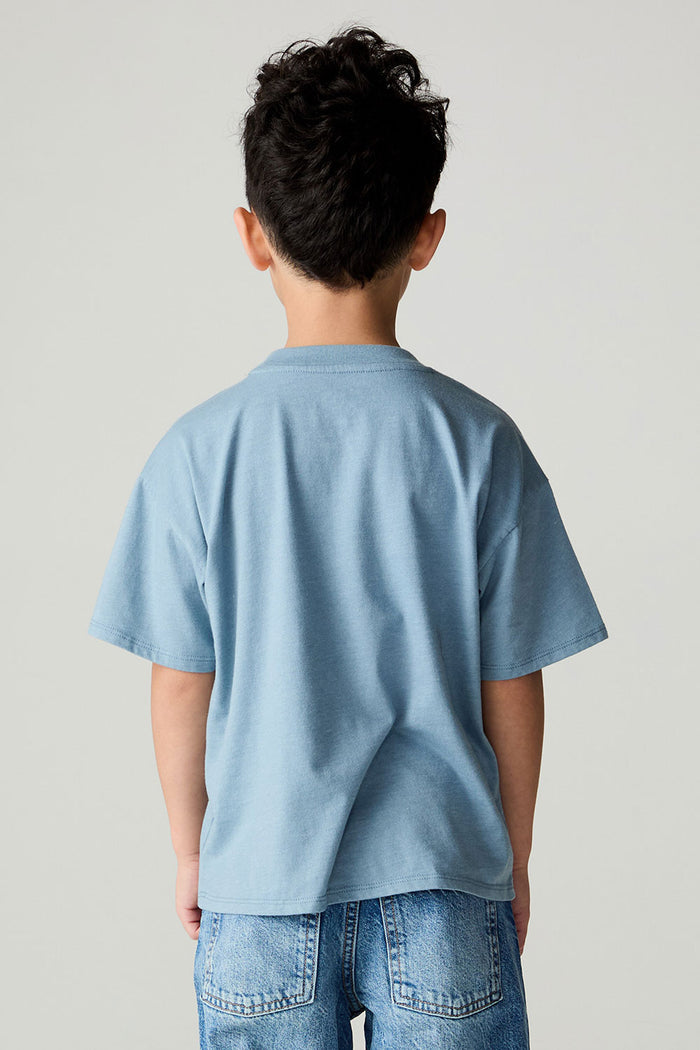 Back view of a boy wearing the Chaser Racers Boys Tee on a neutral background with jeans