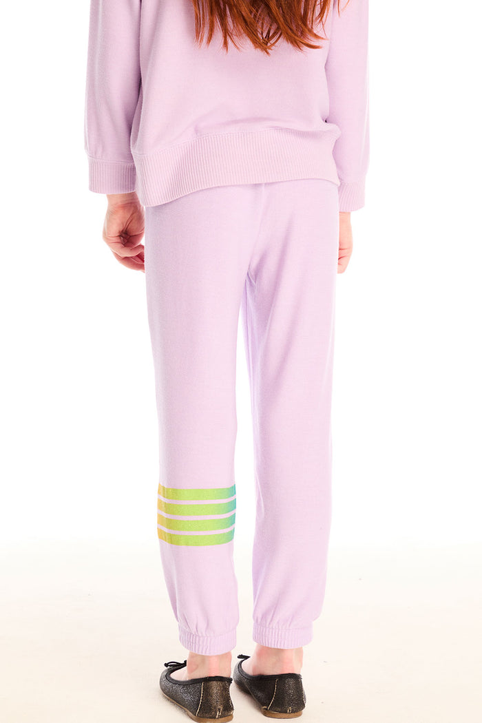 Back view of girl wearing Chaser’s pink Rainbow Glitter Pants with rainbow heart design on a white background