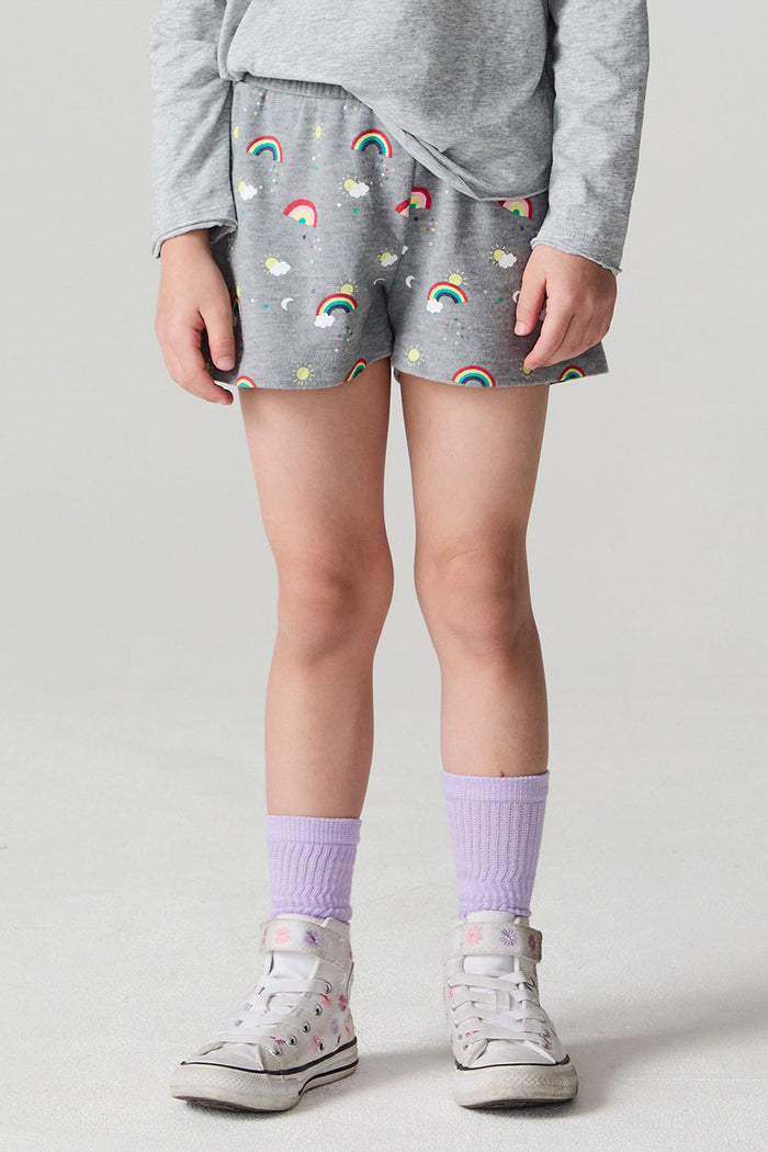 Front view of a girl wearing the Chaser  Rainbow Morning Allover Shorts on a neutral background