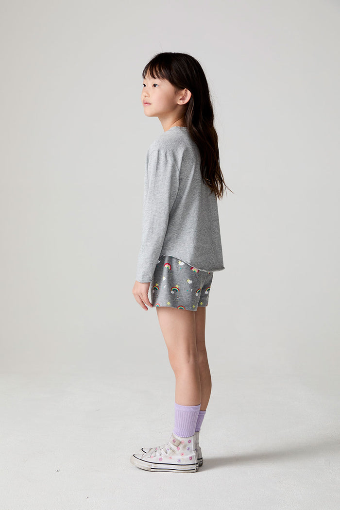 Full body side view of a girl wearing the Chaser Rainbow Morning Long Sleeve on a neutral background
